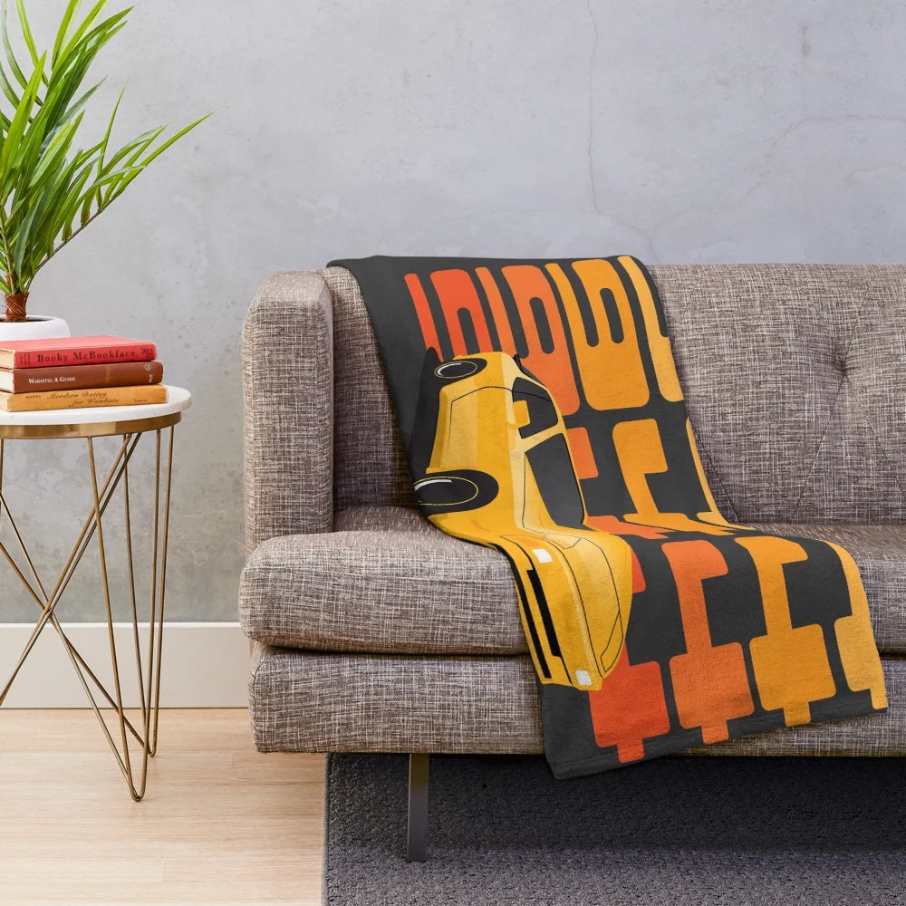 Illustration of a 1986 Porsche 944 in yellow on a plush blanket