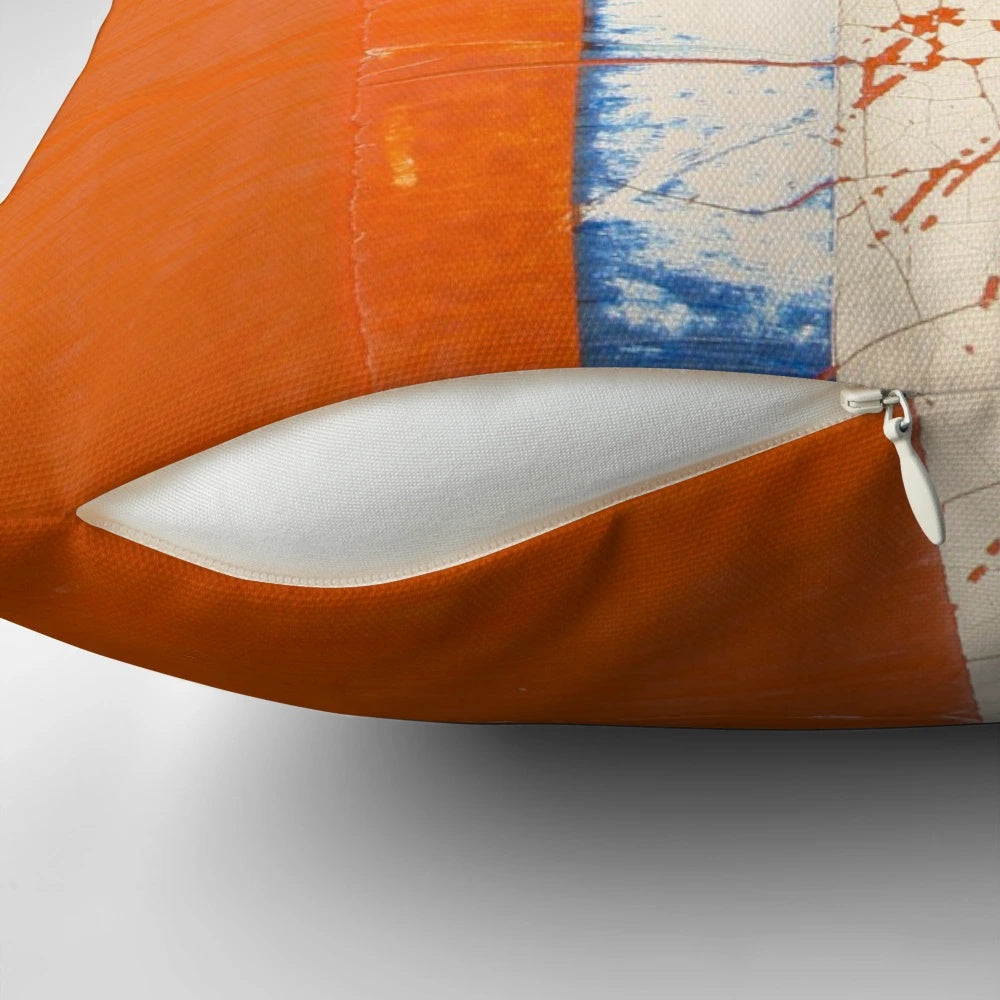 Closeup of a vintage-style abstract patterned pillow with cracked, textured surface in blue, white, and orange colors