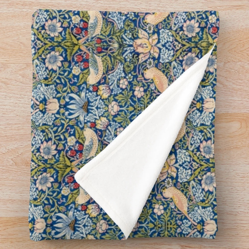 Blue and gold plush blanket with vintage-inspired 'Strawberry Thief' pattern