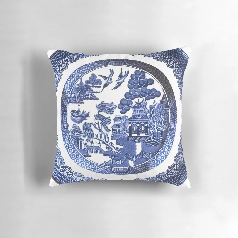 Vintage-inspired blue and white porcelain decorative pillow featuring a classic willow pattern design