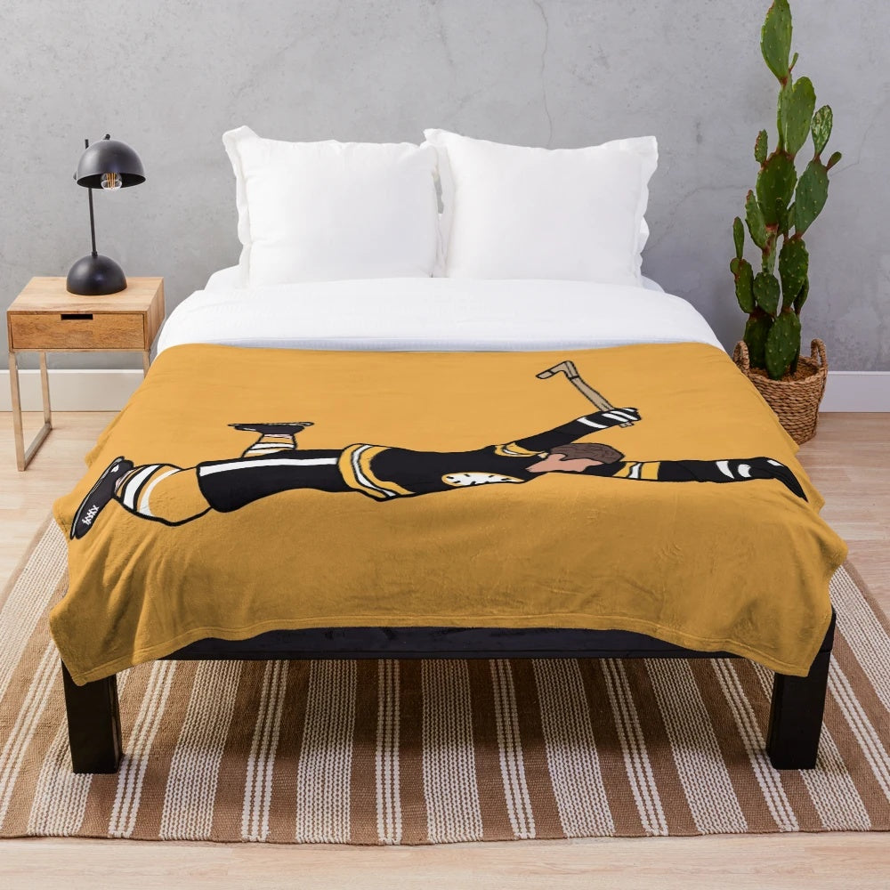 Vintage-inspired plush blanket featuring an iconic photo of Bobby Orr of the Boston Bruins celebrating a goal