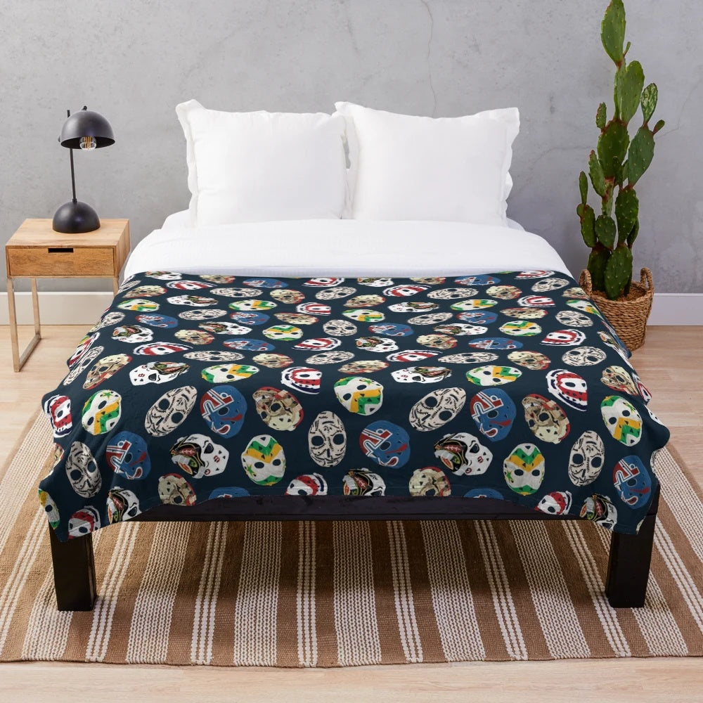 Classic goalie mask pattern on a plush blanket