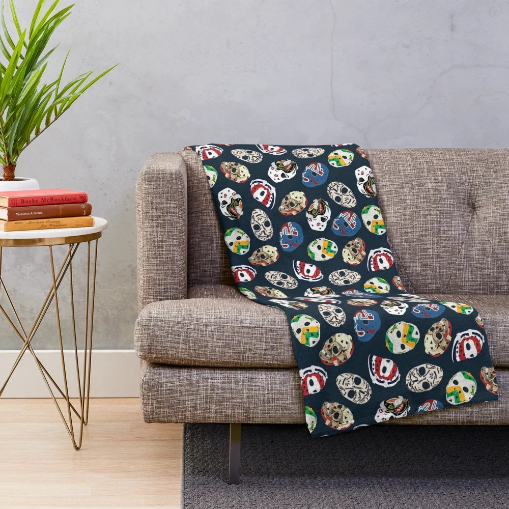 Classic goalie mask pattern on a plush blanket