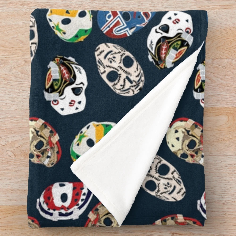 Classic goalie mask pattern on a plush blanket