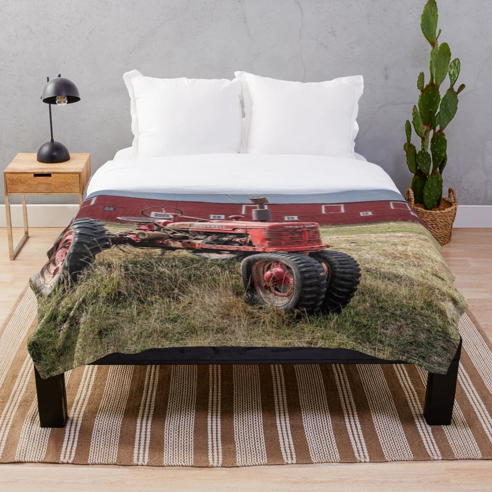Cozy plush blanket featuring a vintage red Farmall tractor