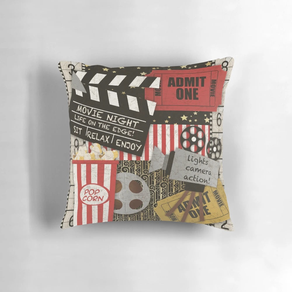 Vintage-inspired home movie-themed throw pillow with film strip, ticket, and movie camera design elements
