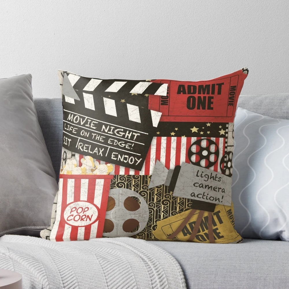 Vintage-inspired home movie-themed throw pillow with film strip, ticket, and movie camera design elements