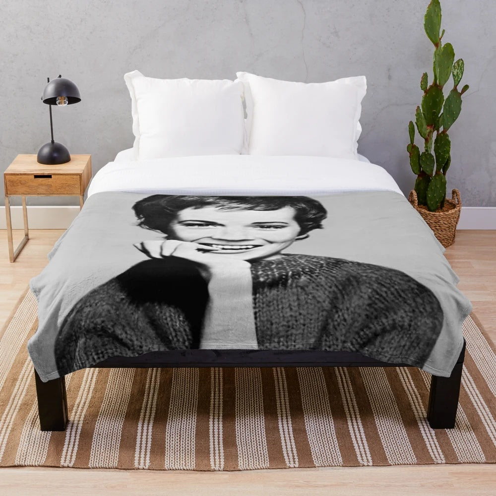 A plush, cozy blanket featuring a vintage-style portrait of actress Julie Andrews