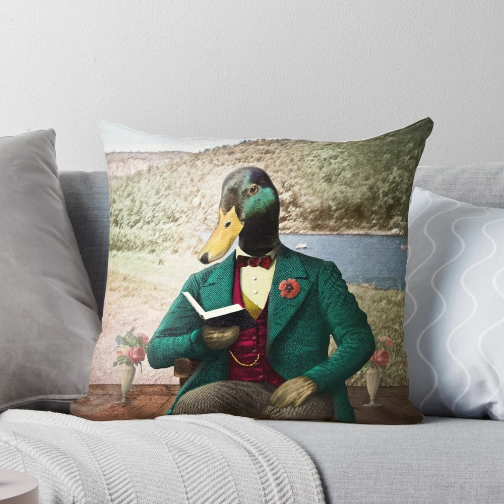 Vintage-inspired pillow featuring an illustration of a mallard duck reading an antique book.