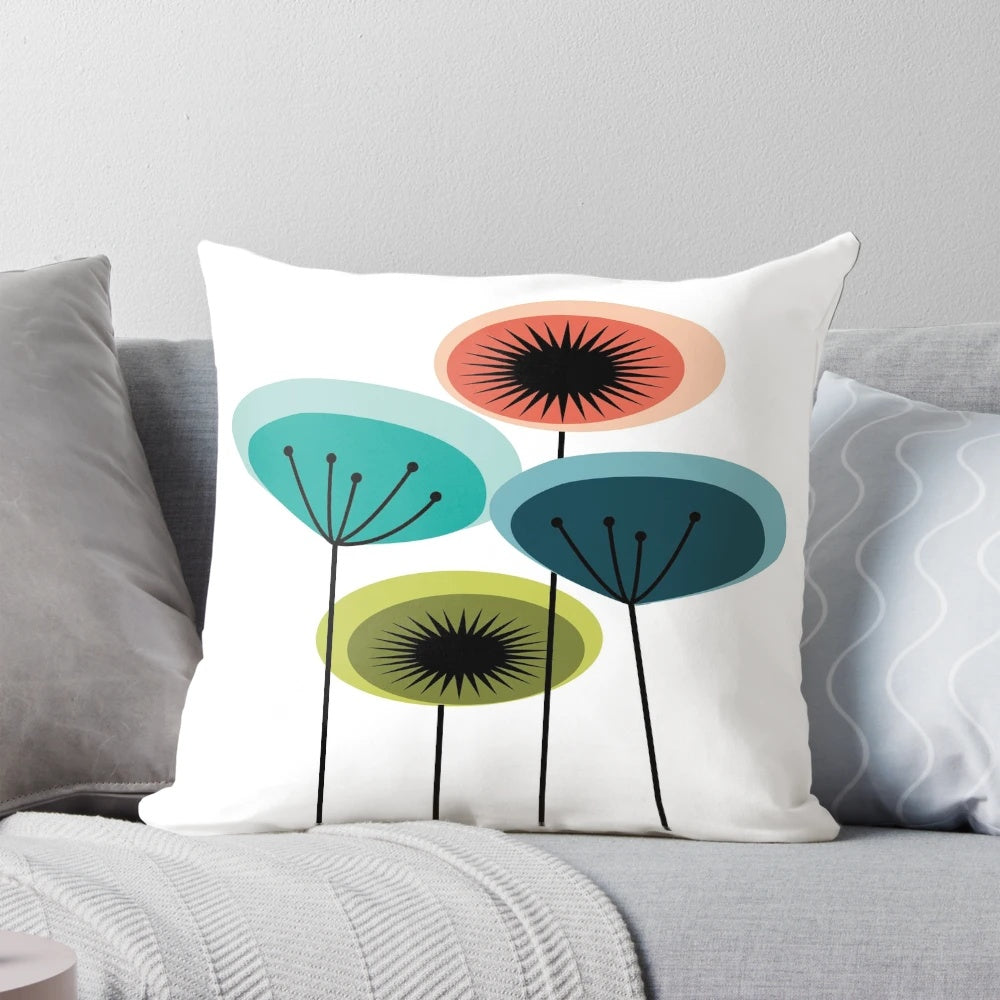 Vibrant mid century modern flower pillow featuring an abstract floral design in a retro 1960s style.