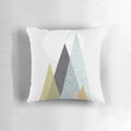 Mid-century style pillow with a geometric mountain design in a scandinavian color palette