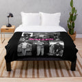Vintage-inspired plush blanket featuring music artist logos and tour themes