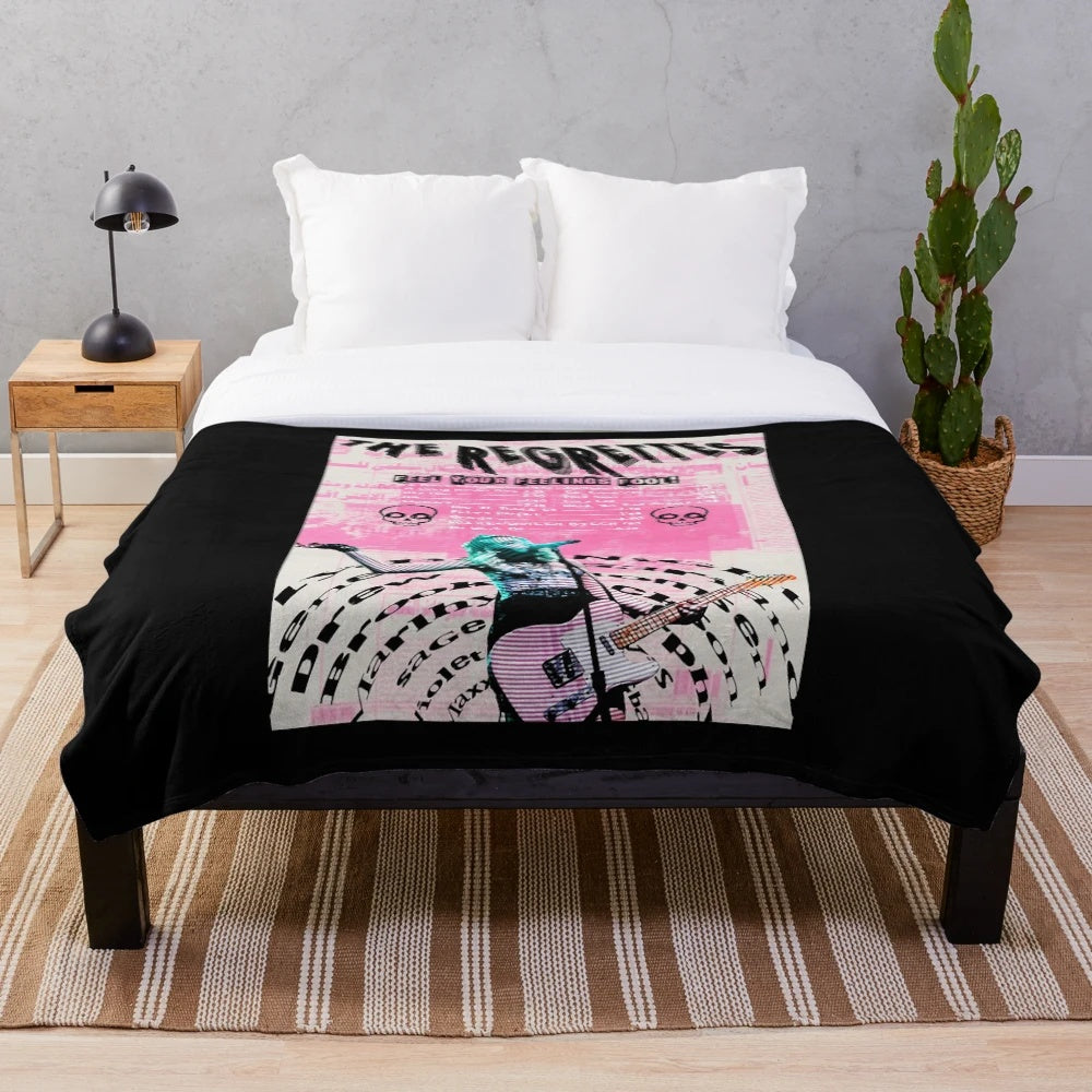 Cozy vintage-style plush blanket featuring The Regrettes band logo and design
