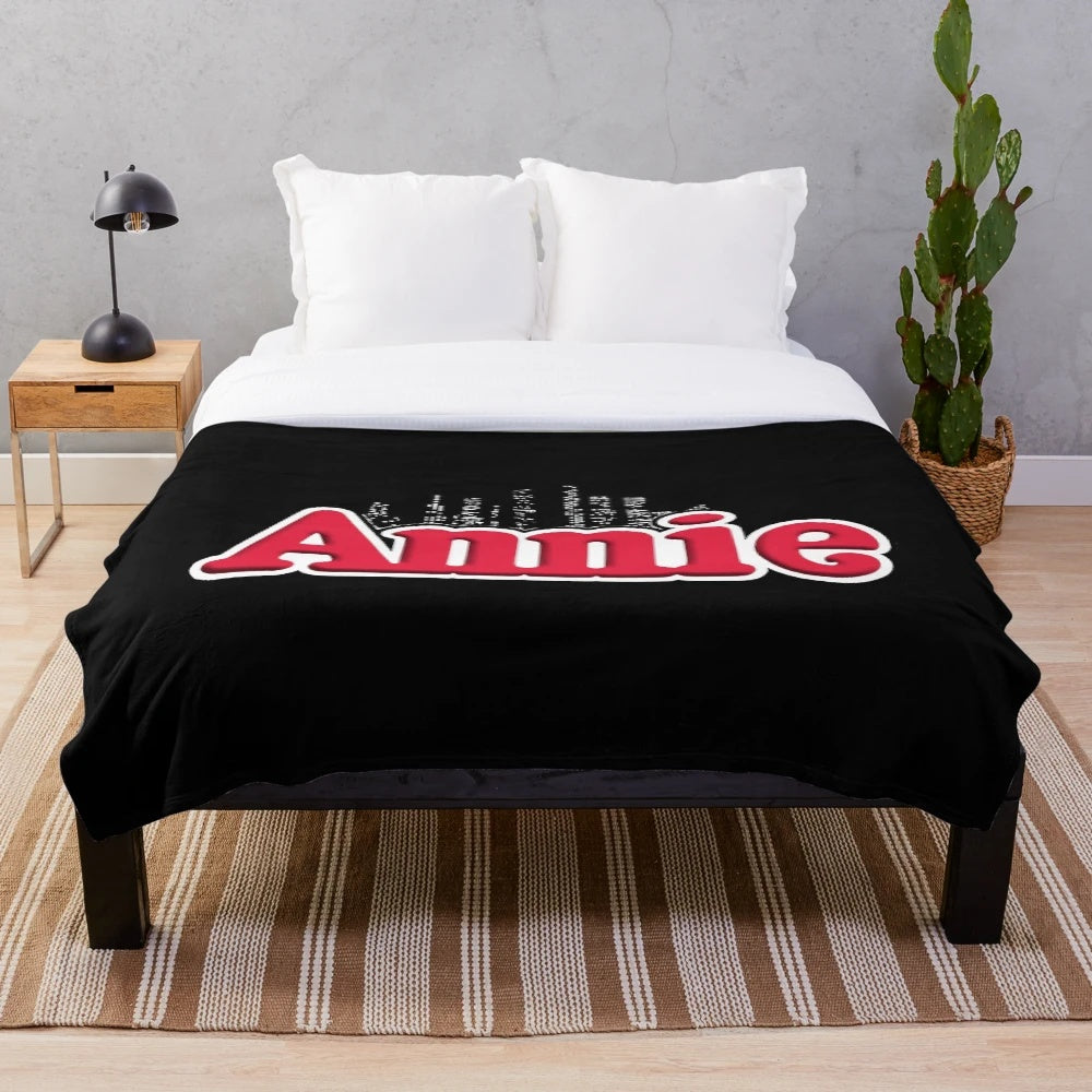 Vintage-inspired plush blanket featuring the iconic Annie musical logo