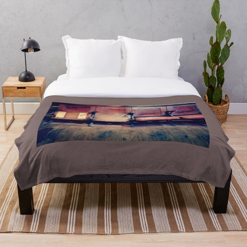 Vintage-inspired plush blanket featuring a design of antique cinema chairs