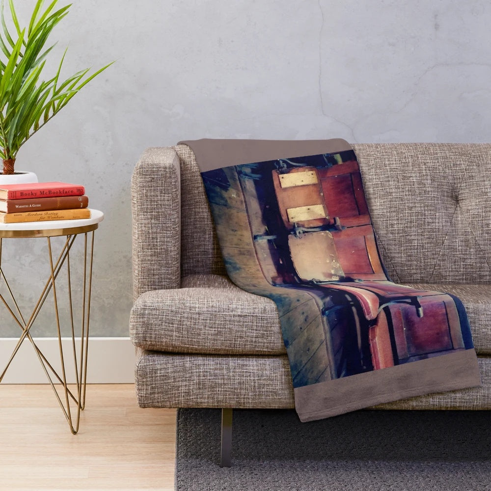 Vintage-inspired plush blanket featuring a design of antique cinema chairs