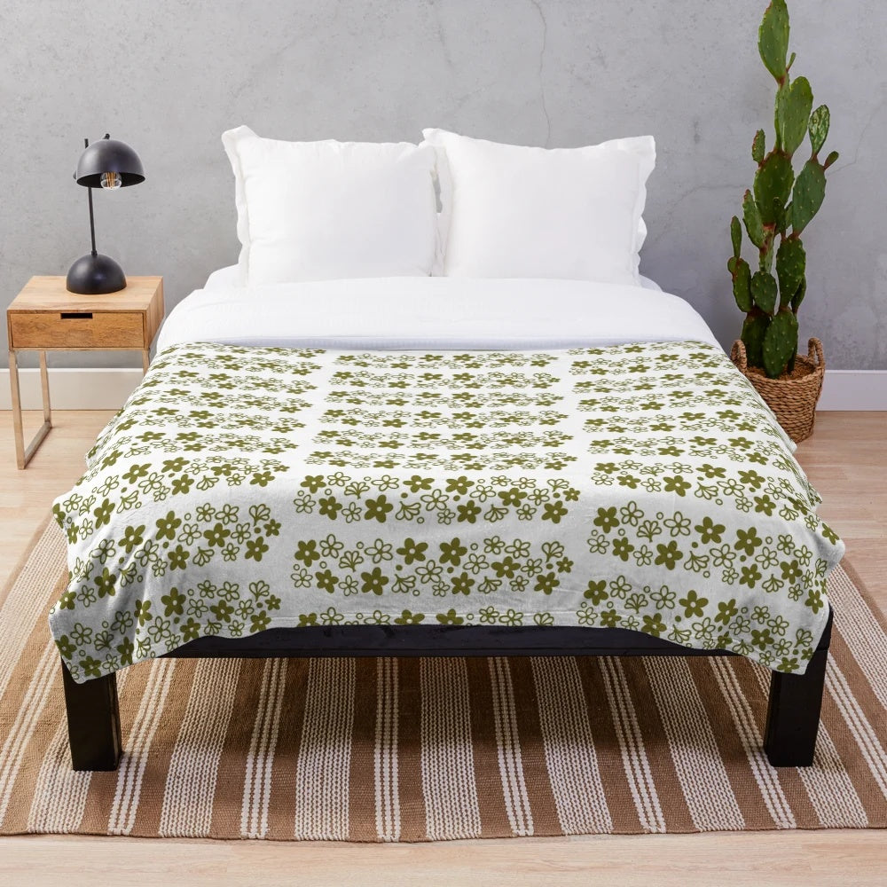 Vintage-inspired plush blanket featuring the iconic Pyrex Spring Blossom design in a cozy avocado green color