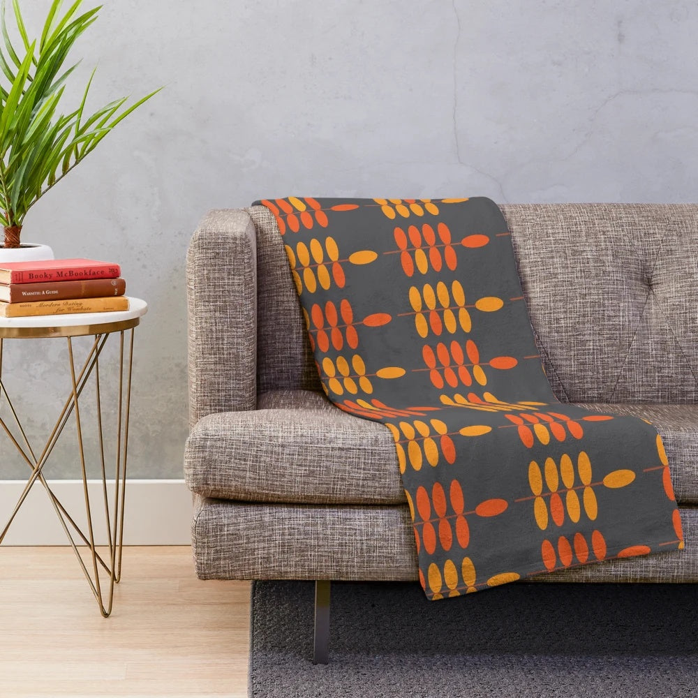Retro orange leaves pattern on a grey plush blanket