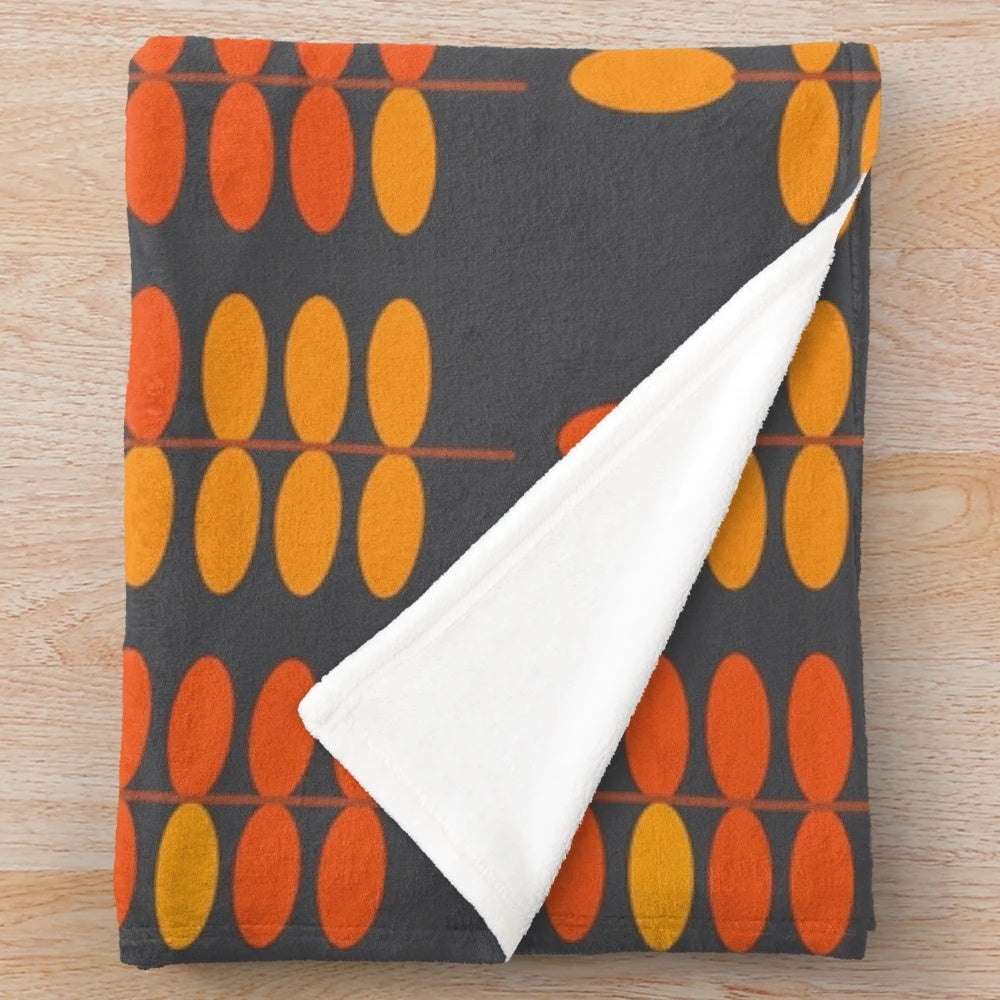 Retro orange leaves pattern on a grey plush blanket