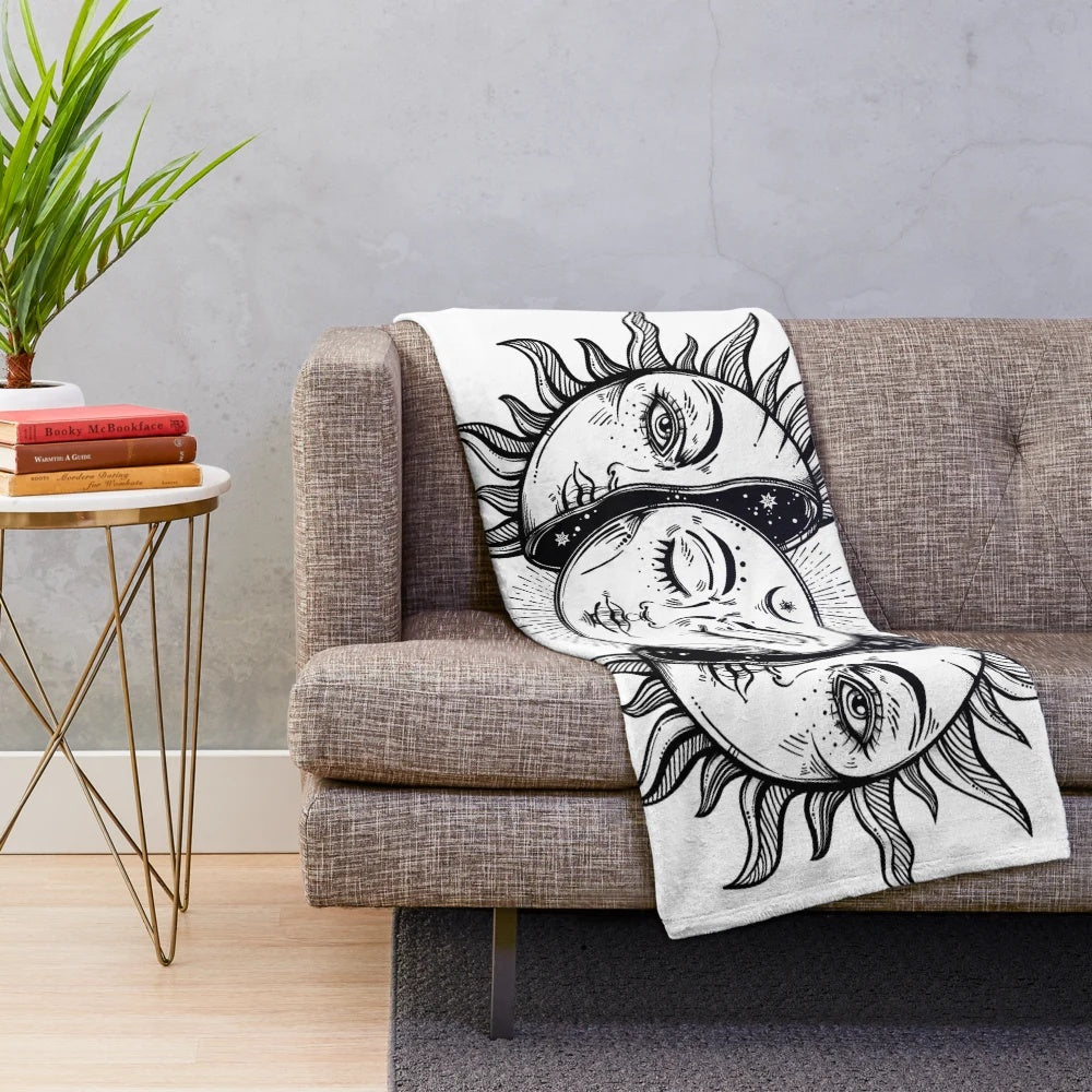 Vintage-inspired plush blanket with a design featuring a solar eclipse, sun, and moon