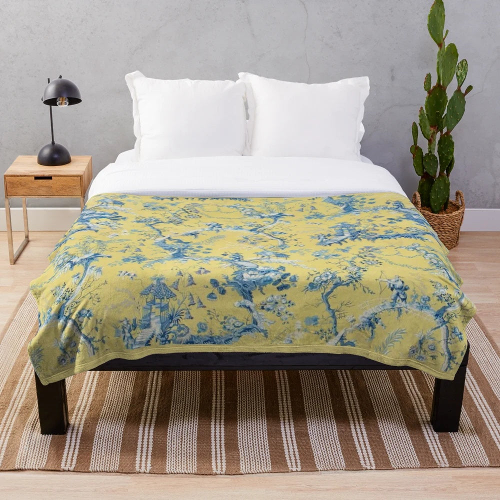 Vintage-inspired blue and yellow toile plush blanket with scenic chinoiserie pattern