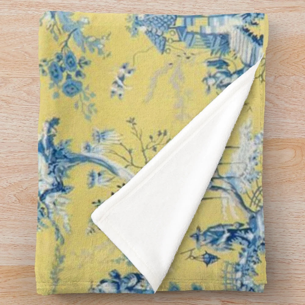 Vintage-inspired blue and yellow toile plush blanket with scenic chinoiserie pattern