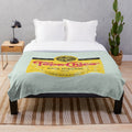 Topo Chico mineral water-inspired plush blanket with a worn, vintage design