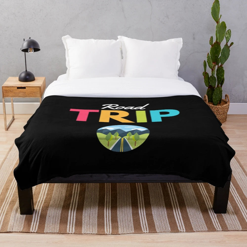 Vintage-inspired travel plush blanket featuring blue mountains and retro road trip design
