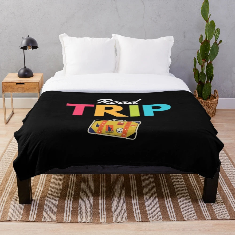 Vintage-inspired plush blanket with retro suitcase and mountain landscape design