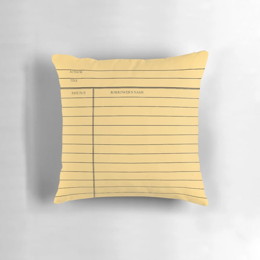 Vintage library card-themed decorative pillow with a gold background