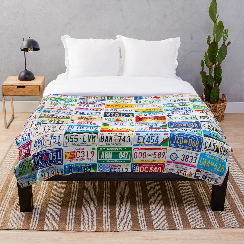 Vintage license plate wall hanging displaying a collection of colorful, weathered number plates