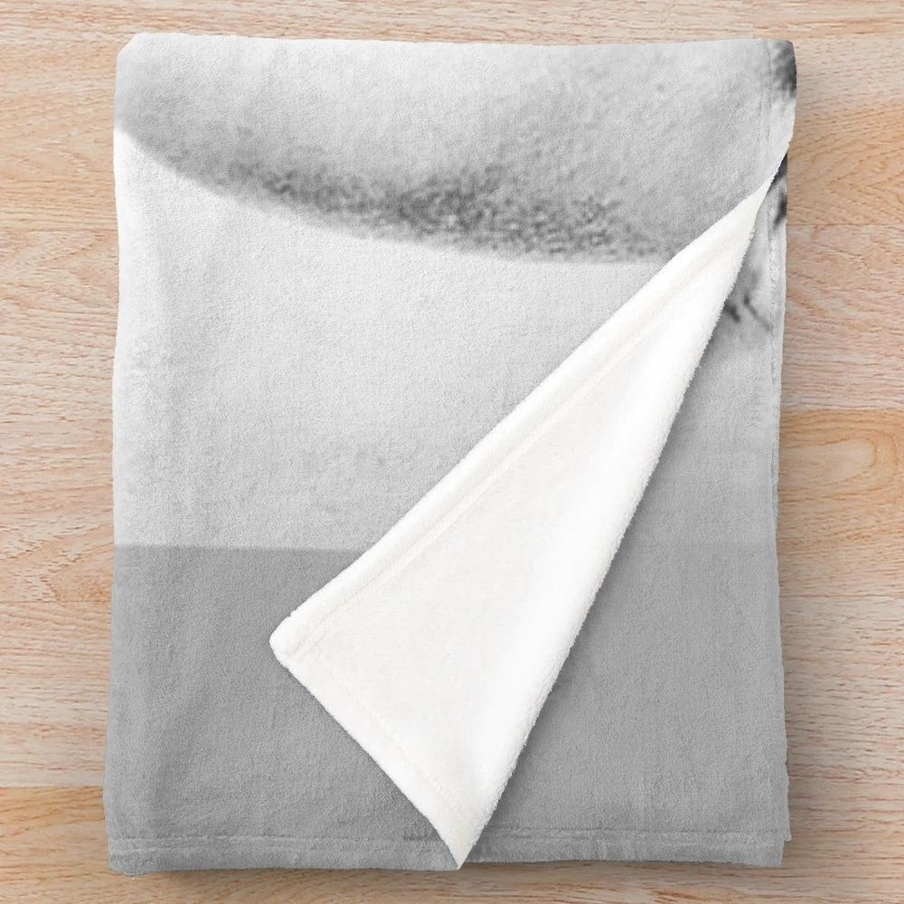 Vintage black and white portrait of Marilyn Monroe on a plush blanket