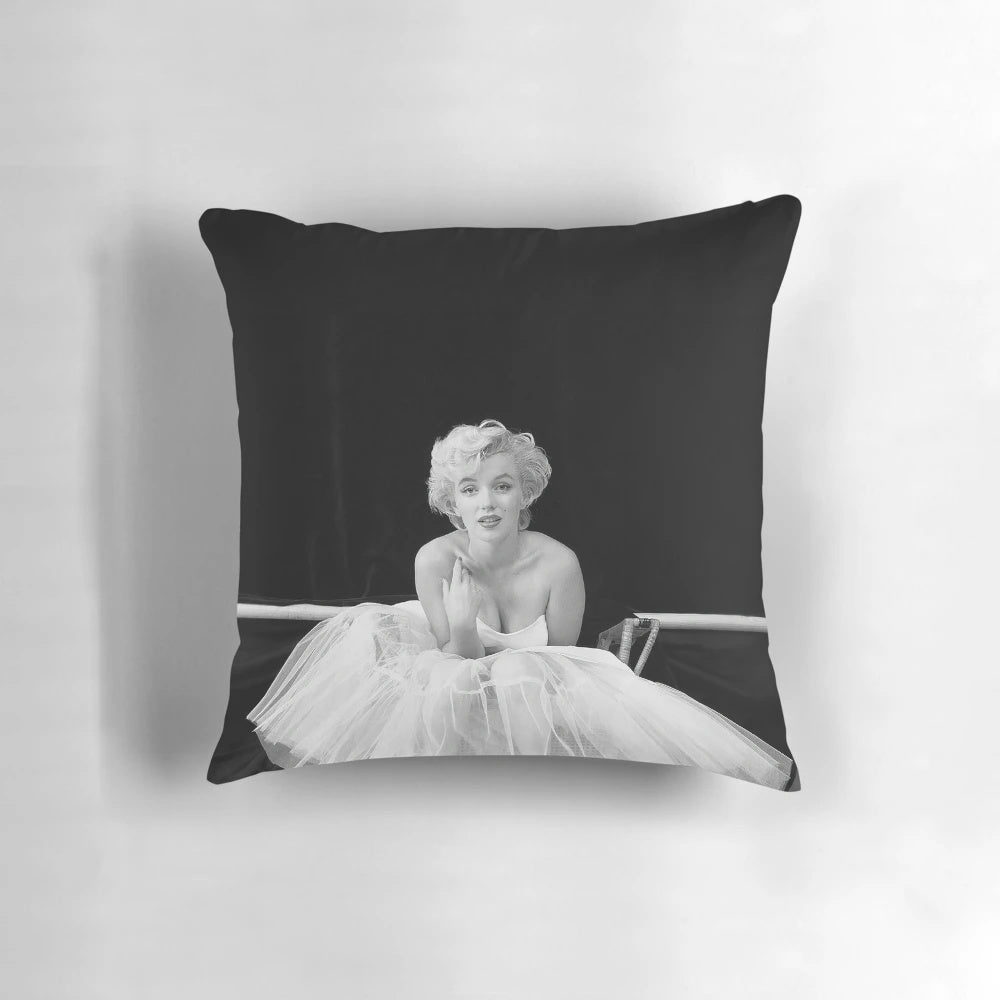 Vintage black and white Marilyn Monroe portrait on a throw pillow, featuring the iconic Hollywood actress in a white dress against a minimalist background.