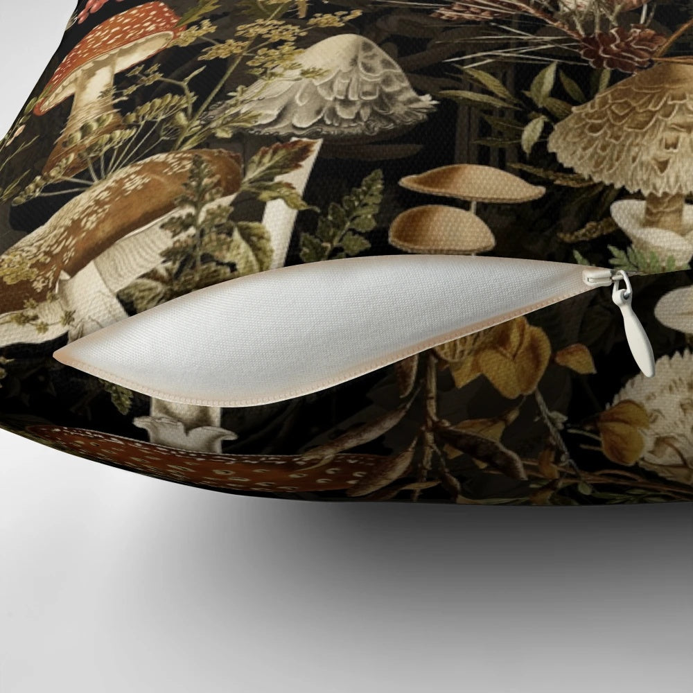 Vintage-style pillow with a dark, moody botanical pattern featuring mushrooms and a night garden scene