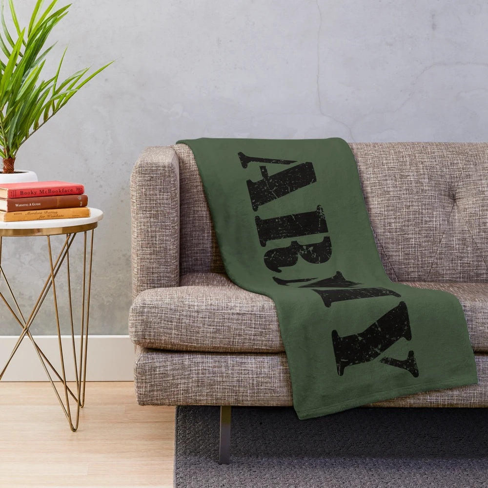 Vintage military-inspired plush blanket with classic army logo and distressed camouflage design