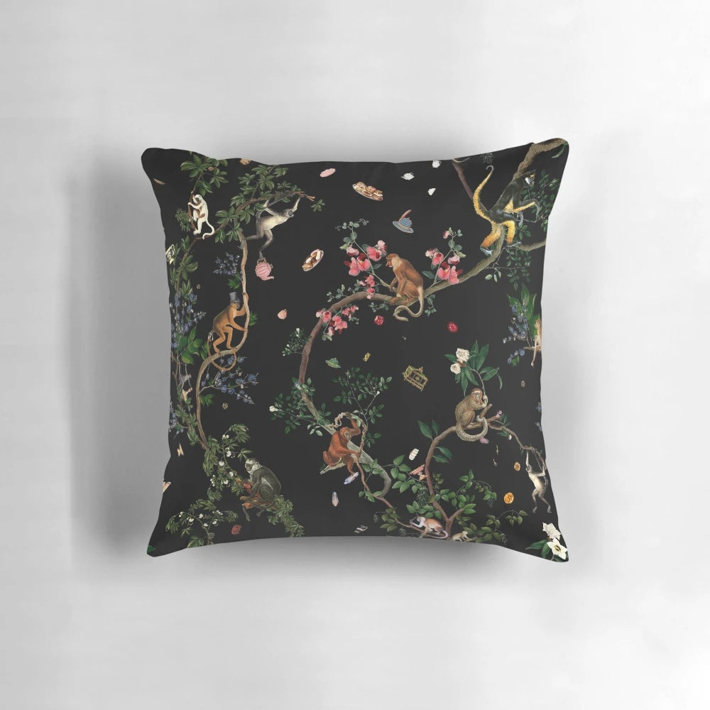 Vintage-inspired monkey pillow with tropical botanical illustrations