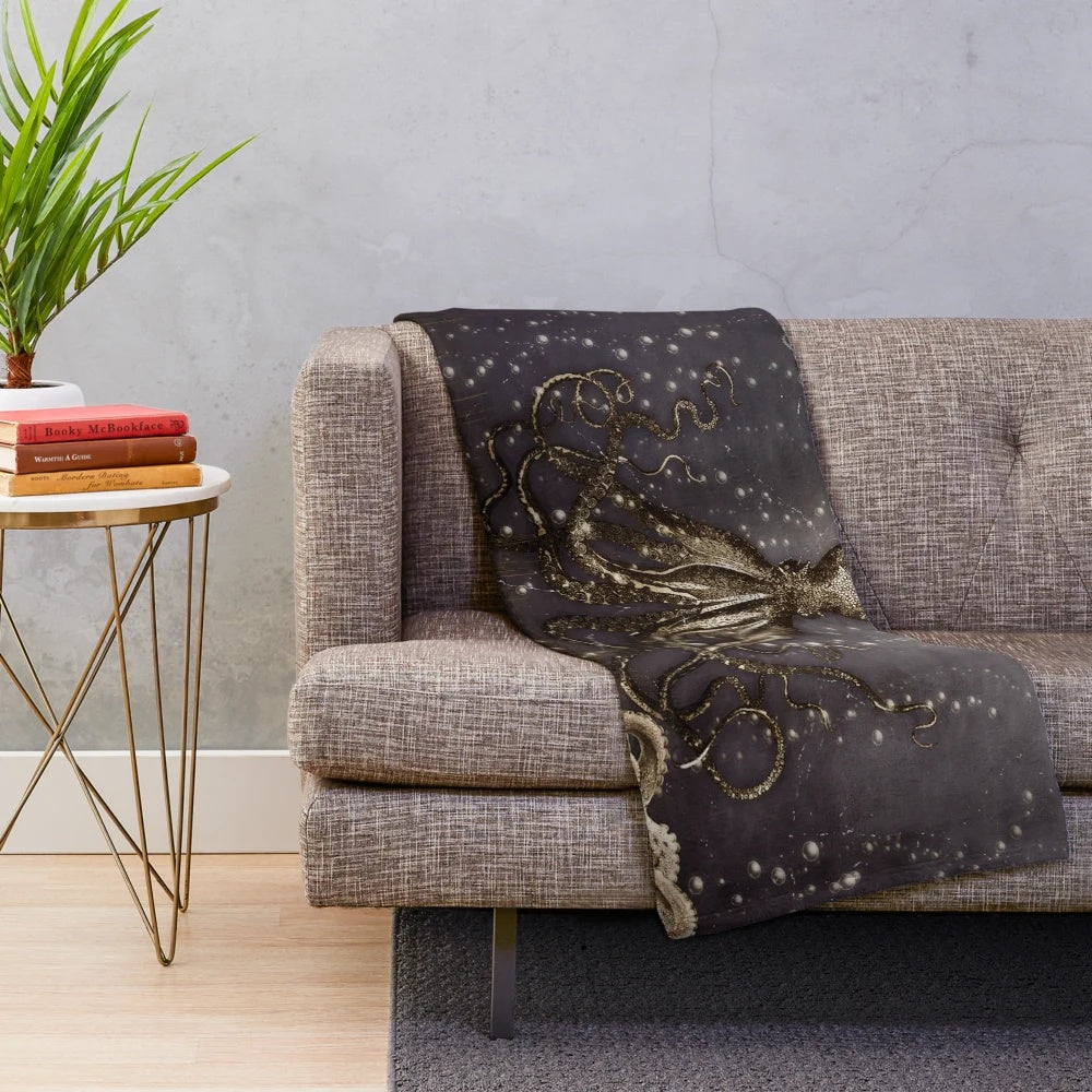 Plush blanket featuring an antique-style illustration of a giant octopus or kraken
