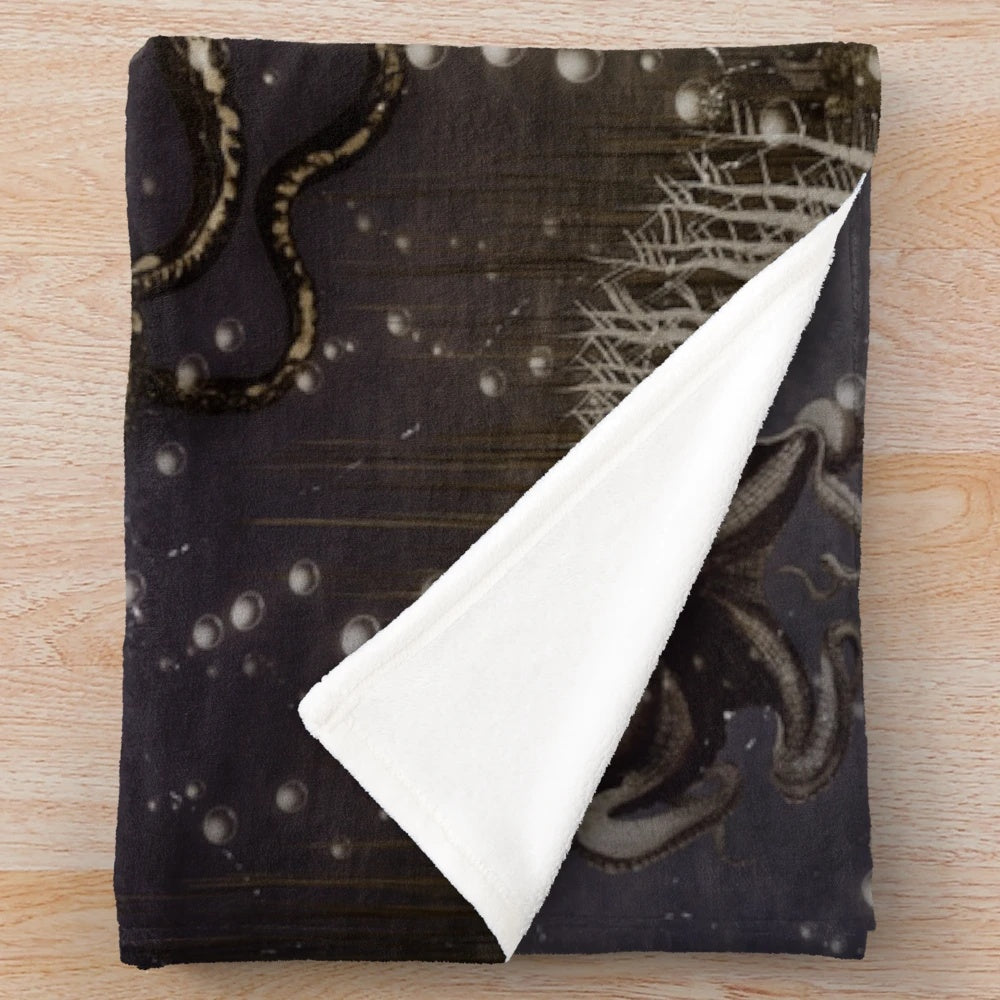 Plush blanket featuring an antique-style illustration of a giant octopus or kraken