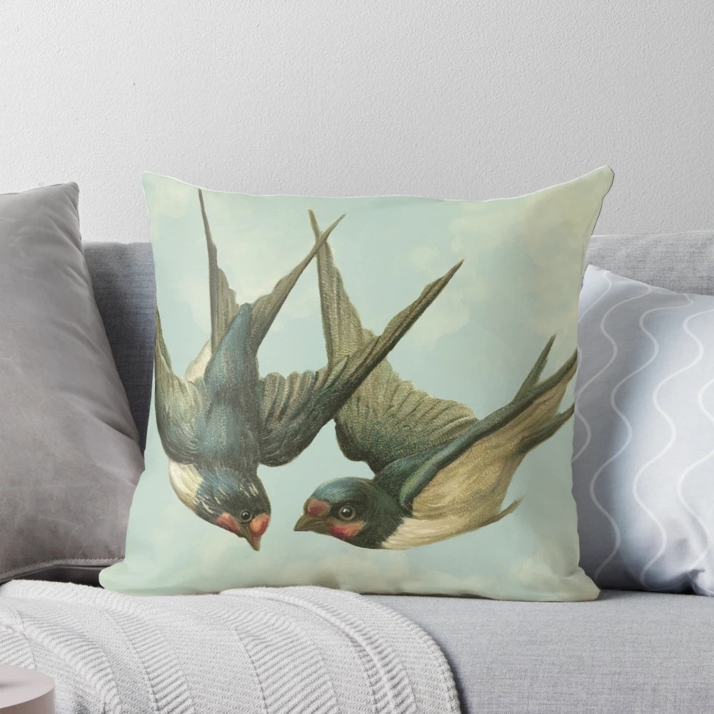 Vintage-inspired decorative pillow featuring a pair of flying swallows against a cloudy blue sky background.