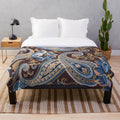 Vintage paisley pattern plush blanket in blue, brown, and beige tones