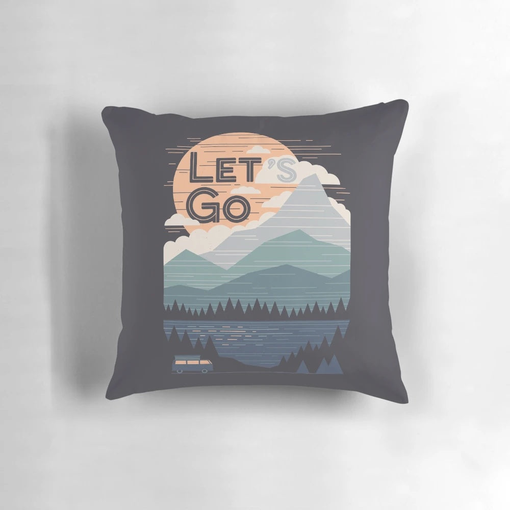 Vintage pastel colored pillow with graphic design of mountains and outdoor adventure quote