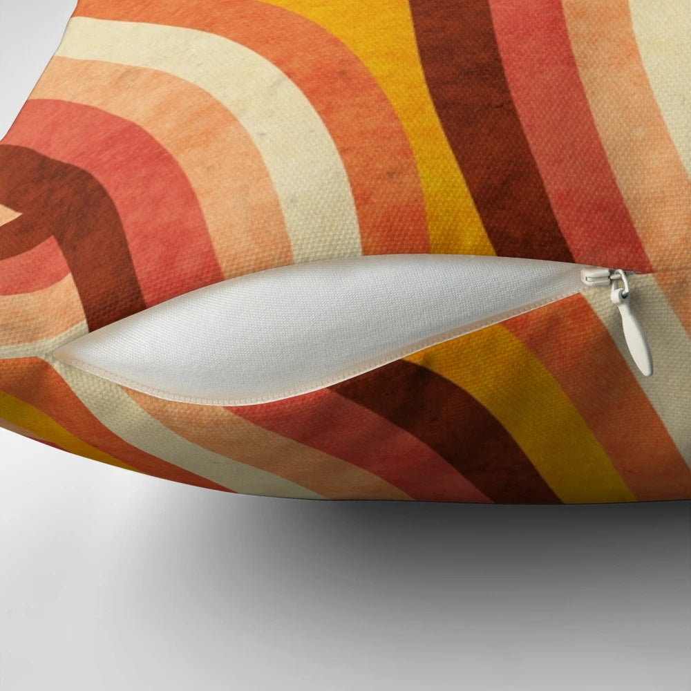 Vintage-style orange, brown, and cream striped pillow with a vibrant rainbow pattern