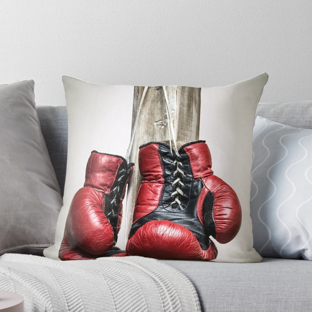 Vintage red boxing gloves printed on a soft, plush throw pillow for sports and boxing-themed home decor.