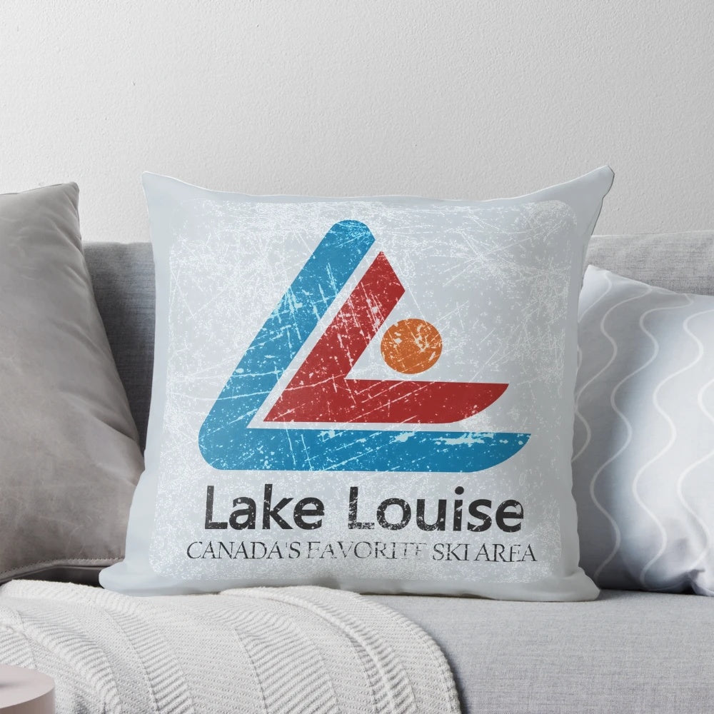 Vintage ski-themed decorative throw pillow with distressed mountain landscape of Lake Louise, Banff, Canada.