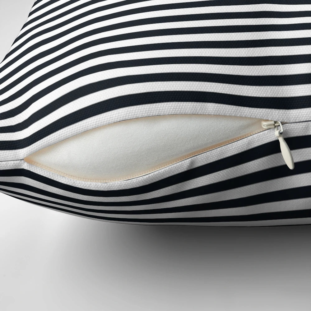 Vintage-inspired black and white striped pillow with a modern, elegant design.