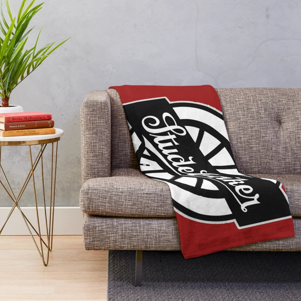 Soft and cozy plush blanket featuring the iconic Studebaker wheel logo in a retro design