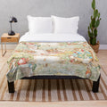 Vintage-style plush blanket featuring a large illustration of anthropomorphic animals from the world of Beatrix Potter