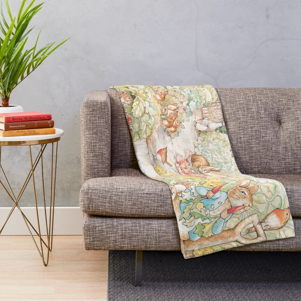 Vintage-style plush blanket featuring a large illustration of anthropomorphic animals from the world of Beatrix Potter