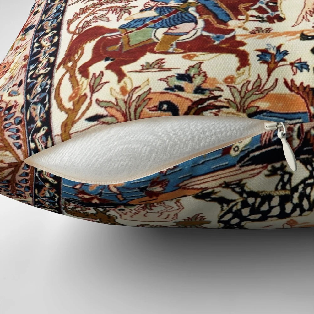A decorative blue and white throw pillow featuring a vintage-inspired floral and animal print inspired by antique Persian rugs.