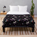 Vintage-style "Labyrinth" plush blanket featuring a colorful 80s pattern with stars, moons, and characters from the cult classic film.
